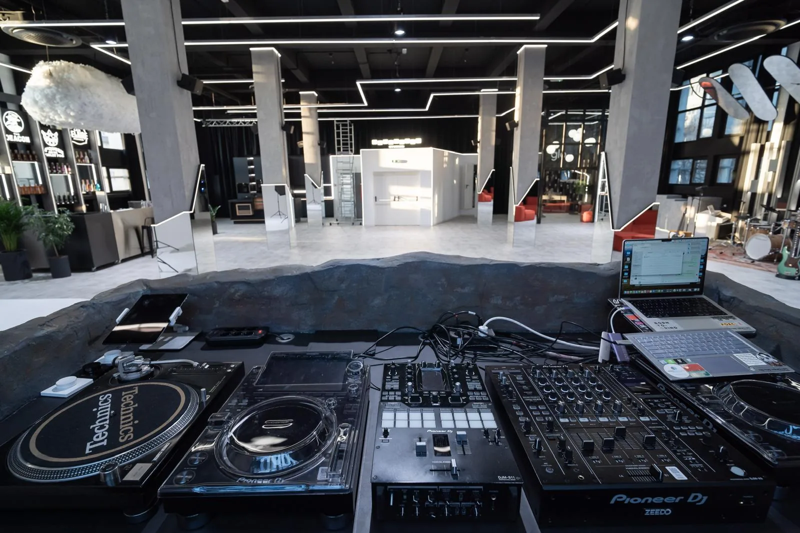 DJ booth and controller setup inside Takeovers Studios